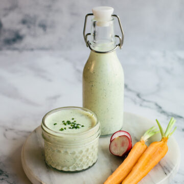 Homemade herby green goddess dressing in a bottle