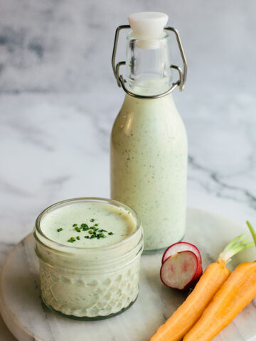 Homemade herby green goddess dressing in a bottle
